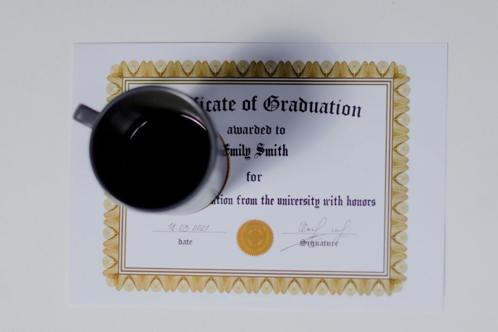 Graduation certificate with a coffee cup placed on top in a flat lay style